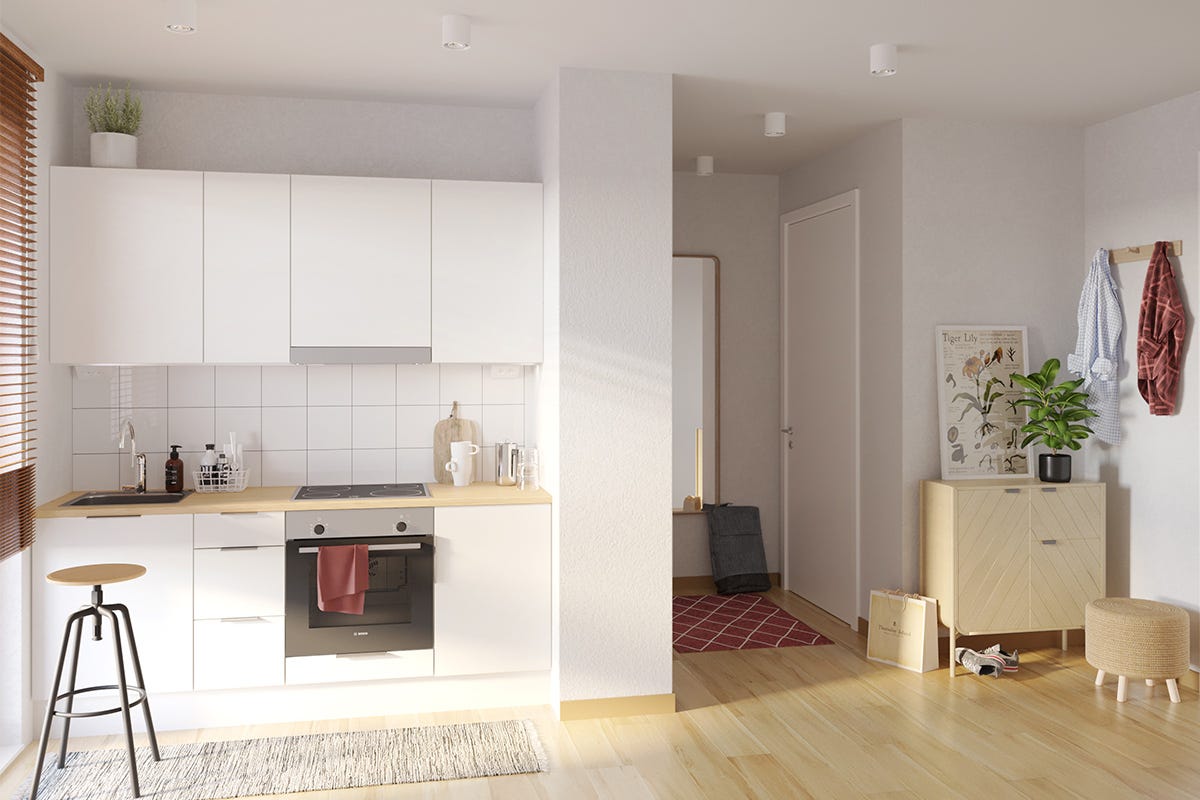 Blick in ein Miniapartment mit Küchenzeile und Mustermöblierung